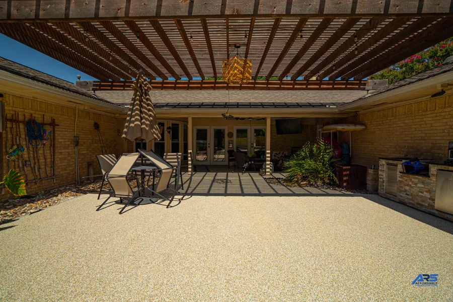 Finished covered Garland patio with tan speckled rubber surfacing
